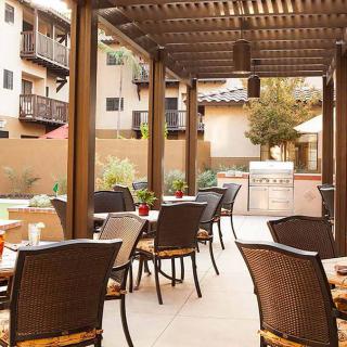 Outdoor patio seating area with a pergola and tables.