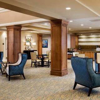 A spacious and elegantly designed hotel lobby with comfortable seating and wooden accents.