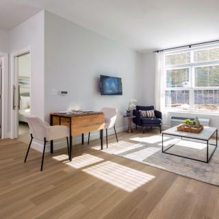 A modern living room with minimalist design and ample natural light.