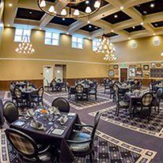 An elegant dining area with well-arranged tables and chandeliers.