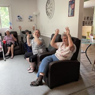Seniors enjoying a lively moment together in a communal space.