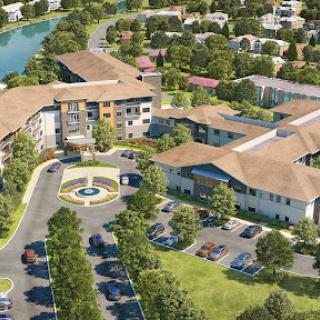 Aerial view of a modern community development featuring residential buildings and landscaped areas.