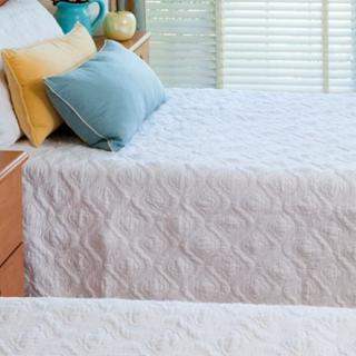 A cozy bedroom setup with neatly made beds adorned with decorative pillows.
