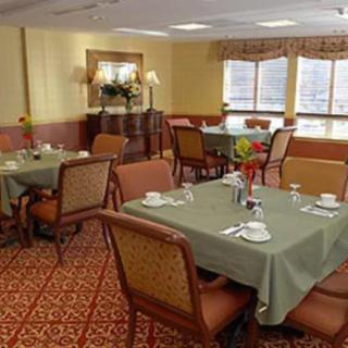 A neatly arranged dining room with tables set for a meal.