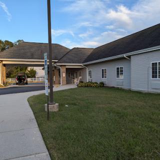 A view of a modern building with a welcoming entrance and landscaped surroundings.