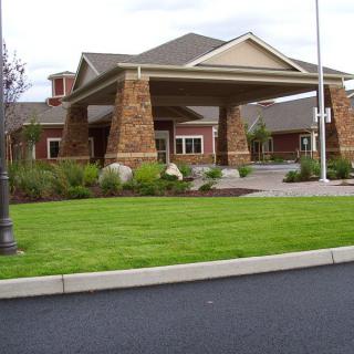 A modern building with a covered entrance and well-maintained landscaping.