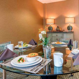 An elegantly set dining table with stylish decor and warm lighting.