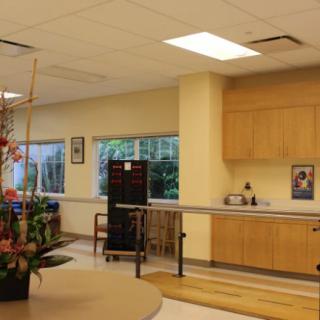 A physical therapy room equipped with parallel bars and healthcare equipment.