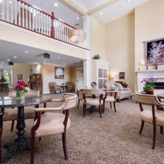 A spacious, elegantly designed living and dining area with modern furniture and bright lighting.