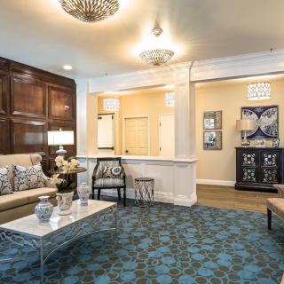 A well-decorated living room with elegant furnishings and a chandelier.