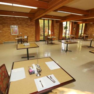An empty restaurant with tables and chairs arranged for social distancing.