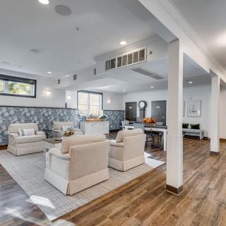 A modern living room with comfortable seating, natural light, and hardwood flooring.