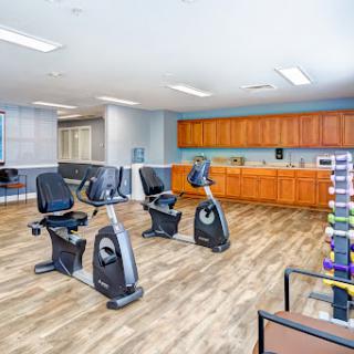 A modern exercise area featuring stationary bikes and workout accessories.