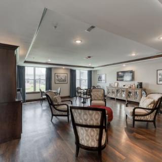 A spacious living room with elegant furniture and large windows.