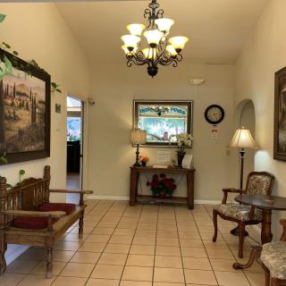 A cozy lobby interior with elegant furnishings and a chandelier.