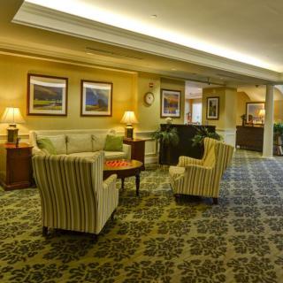A cozy hotel lobby with comfortable seating and warm lighting.