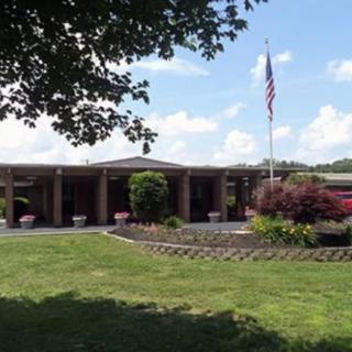 A building with a garden and an American flag on a sunny day.