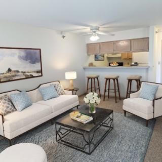A cozy and modern living room with stylish furniture and an open kitchen layout.