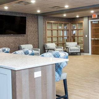 A modern lobby with comfortable seating and a television.