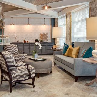 A stylish open-concept living room with modern furniture and a cozy kitchen area.