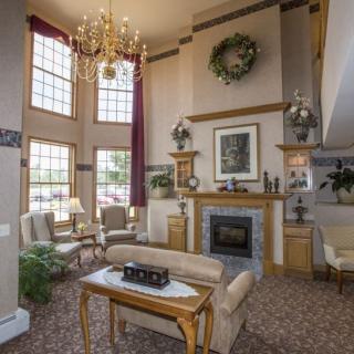 A spacious living room with high ceilings, classic decor, and a cozy fireplace.