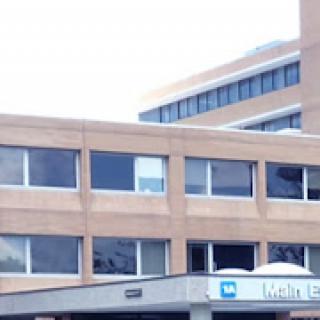A view of a hospital building featuring multiple windows and modern architecture.