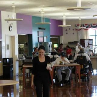 A group of people enjoying a meal in a communal dining area.