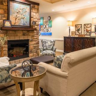 A cozy living room with a fireplace and elegant seating arrangements.