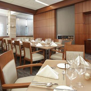 Elegant dining area with neatly set tables and chairs.