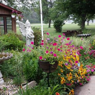 A beautiful garden filled with vibrant flowers and a decorative statue.
