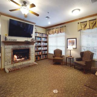 A cozy living room with a fireplace, television, and comfortable seating.