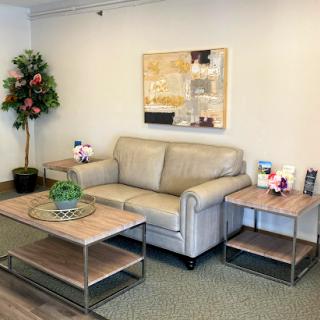 A cozy and modern living room setup featuring a comfortable sofa, stylish tables, and decorative elements.