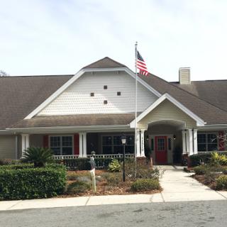 A welcoming residential building with a flag proudly displayed in the front yard.