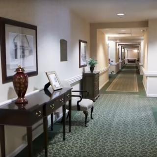 A well-lit hallway with elegant furniture and decor.