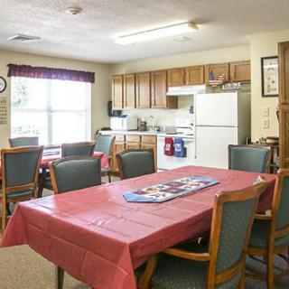 A cozy kitchen and dining area with a table, chairs, and appliances.
