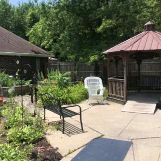 A tranquil garden area with a gazebo and outdoor seating.