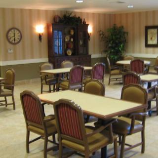 An empty dining room with tables and chairs arranged neatly.