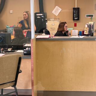 A busy reception area with staff attending to tasks.