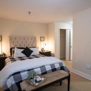 A cozy and stylishly decorated bedroom with a double bed, nightstands, and soft lighting.