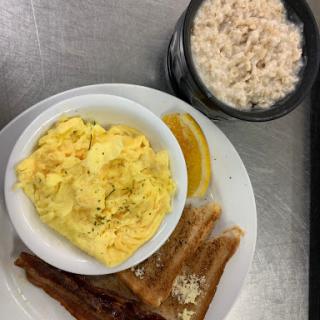 A hearty breakfast featuring scrambled eggs, toast, and oatmeal.