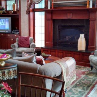 A cozy living room with elegant furnishings and a fireplace.