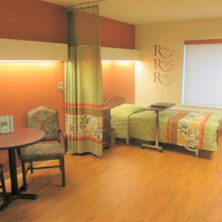 A well-designed hospital room featuring comfortable seating and a cozy atmosphere.