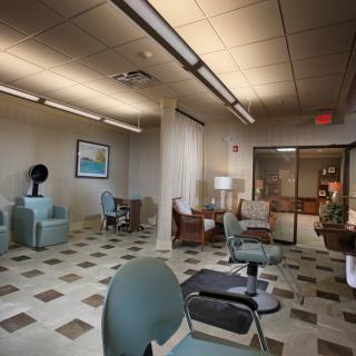 An empty waiting room with chairs and subdued lighting.