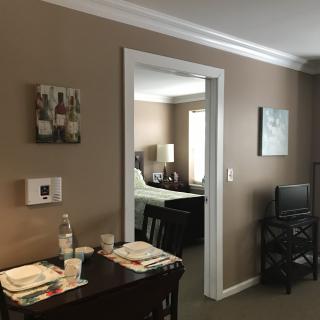 View of a cozy apartment interior featuring a dining area and bedroom.