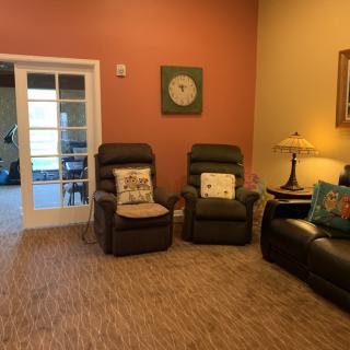 Cozy living room with recliners, sofa, and decorative elements.