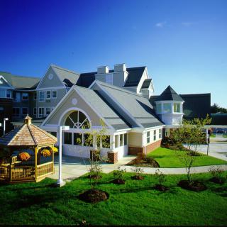 A picturesque house with a well-maintained garden and a charming gazebo.