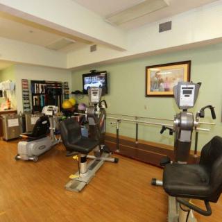 A well-equipped gym with exercise machines and a television for entertainment.
