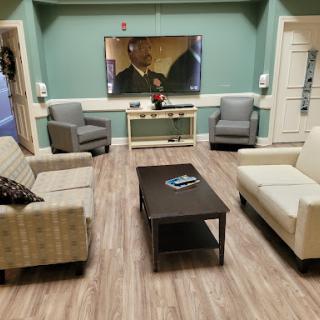A cozy living room setup featuring comfortable seating and a television.