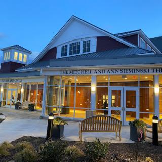 A beautifully lit community center entrance at dusk.