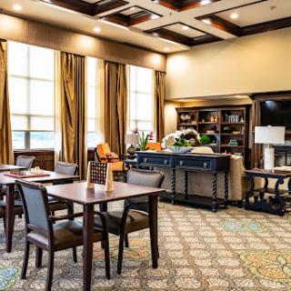 A cozy lounge area featuring comfortable seating and a well-lit ambiance.